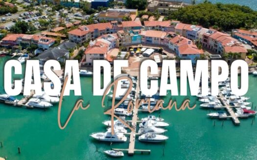 Aerial view of a marina at Casa de Campo in the Dominican Republic, with boats and red-roofed buildings, overlaid by bold white text reading Casa de Campo Dominican Republic.