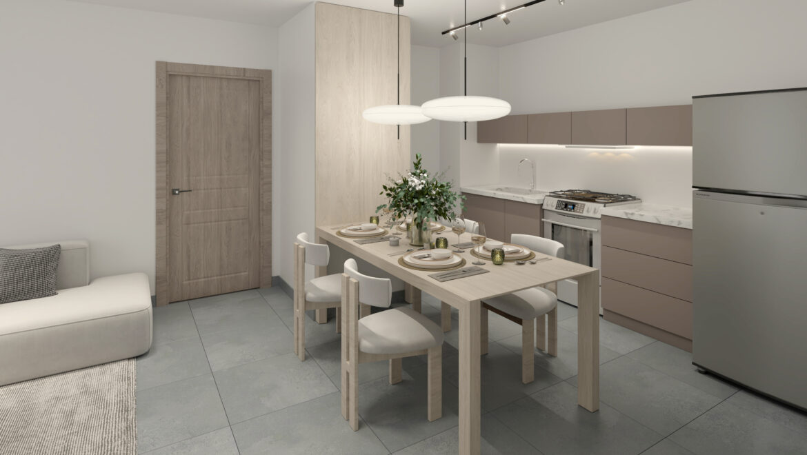 Open-plan kitchen and dining area with a light wood table set for six, white chairs, and oval pendant lights above.