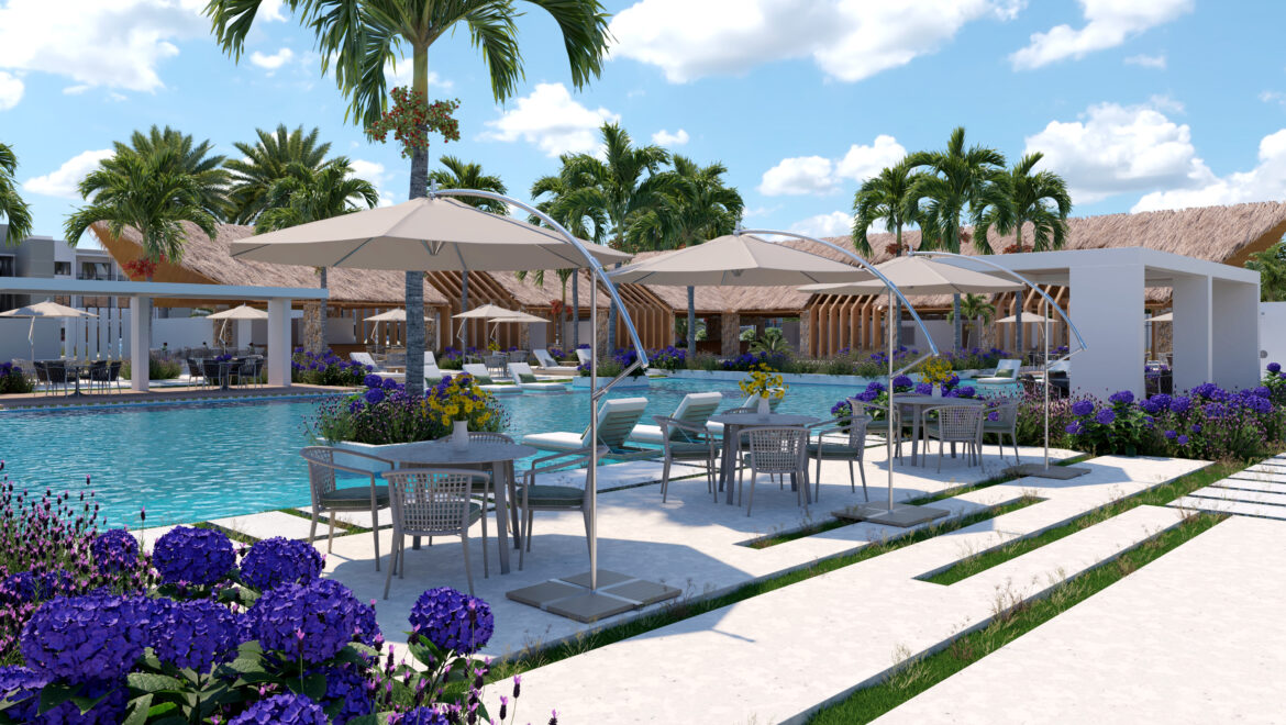 Resort pool area with beige umbrellas, lounge chairs, and palm trees amid purple flowers and white stone pathways under a bright blue sky