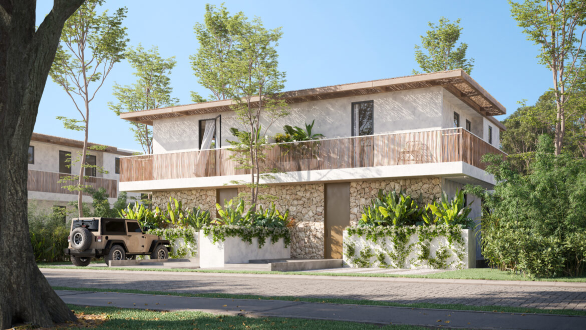 Modern two-story house with a stone base, white exterior, and wooden balcony railing surrounded by lush tropical plants and trees; a tan off-road SUV is parked in the driveway.