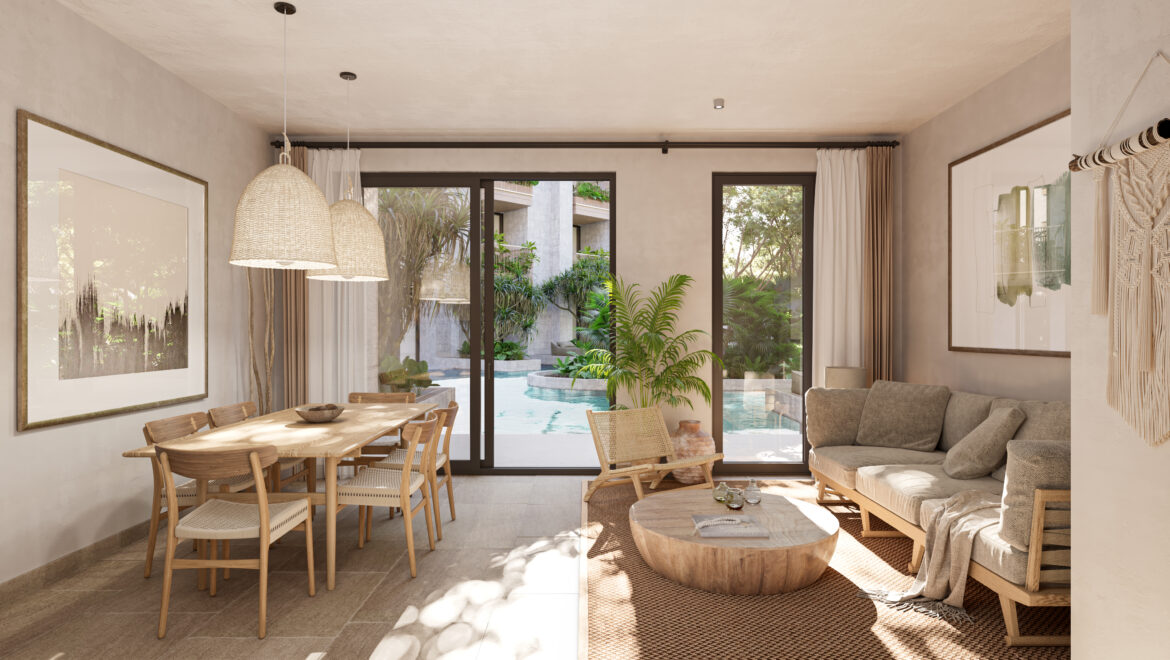 Open living and dining area with a wooden table, woven pendant lights, and glass doors revealing a sunny outdoor pool and garden.