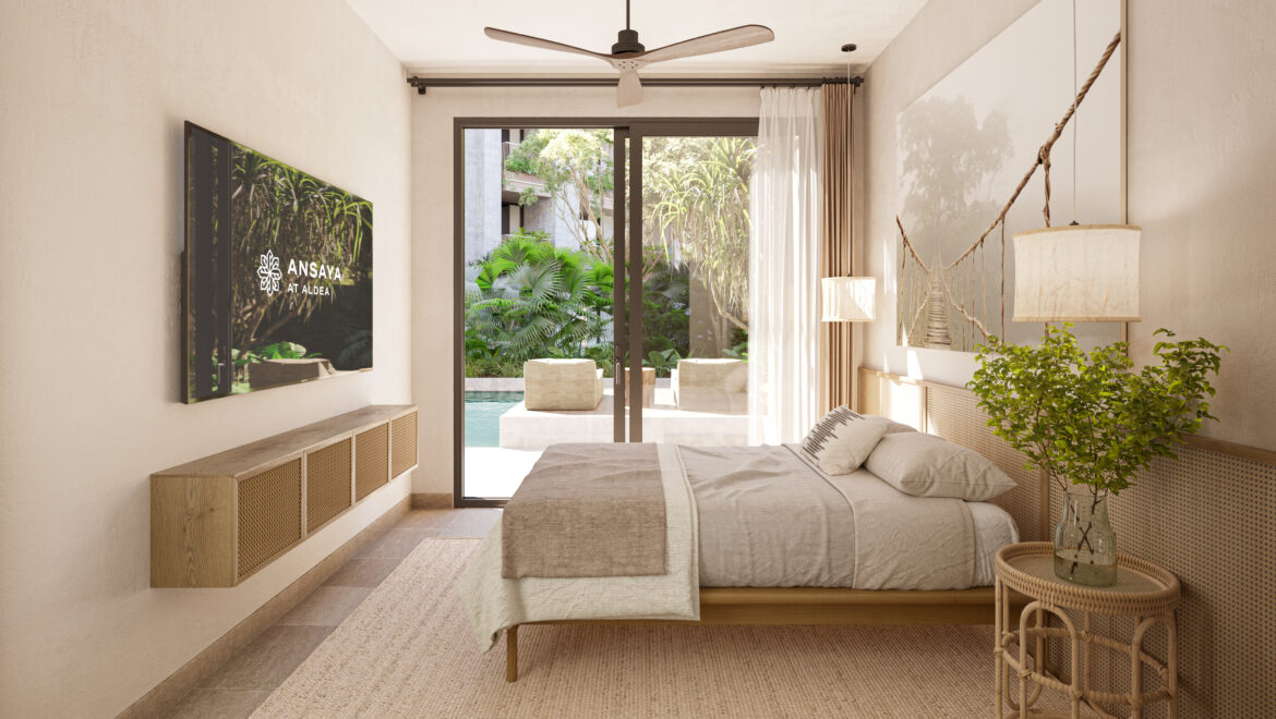 Hotel bedroom with a wall-mounted TV, beige bedding, and a sliding glass door opening to a tropical outdoor pool area.