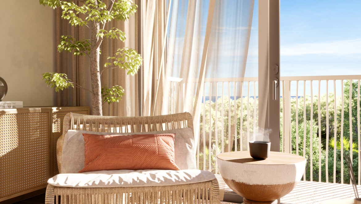 Sunlit living space with a tall indoor tree, beige wicker furniture, and sheer curtains beside an open glass door leading to a balcony with a blue sky outside.