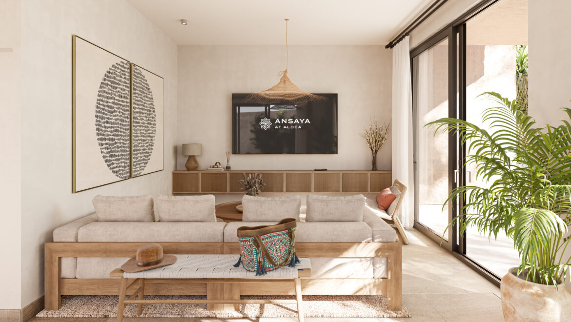 Living room with a beige sectional, wooden coffee table, wall art, and a woven pendant light.