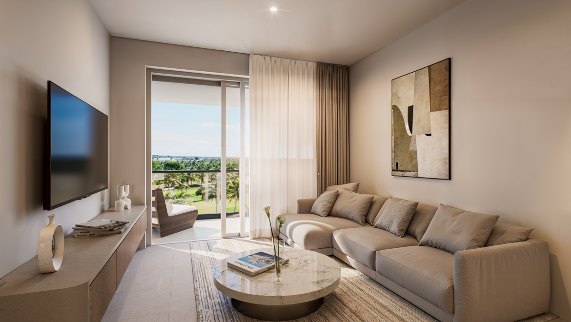 Modern living room with beige sofa, marble coffee table, and wall art; large window opens to balcony with sunny landscape outside