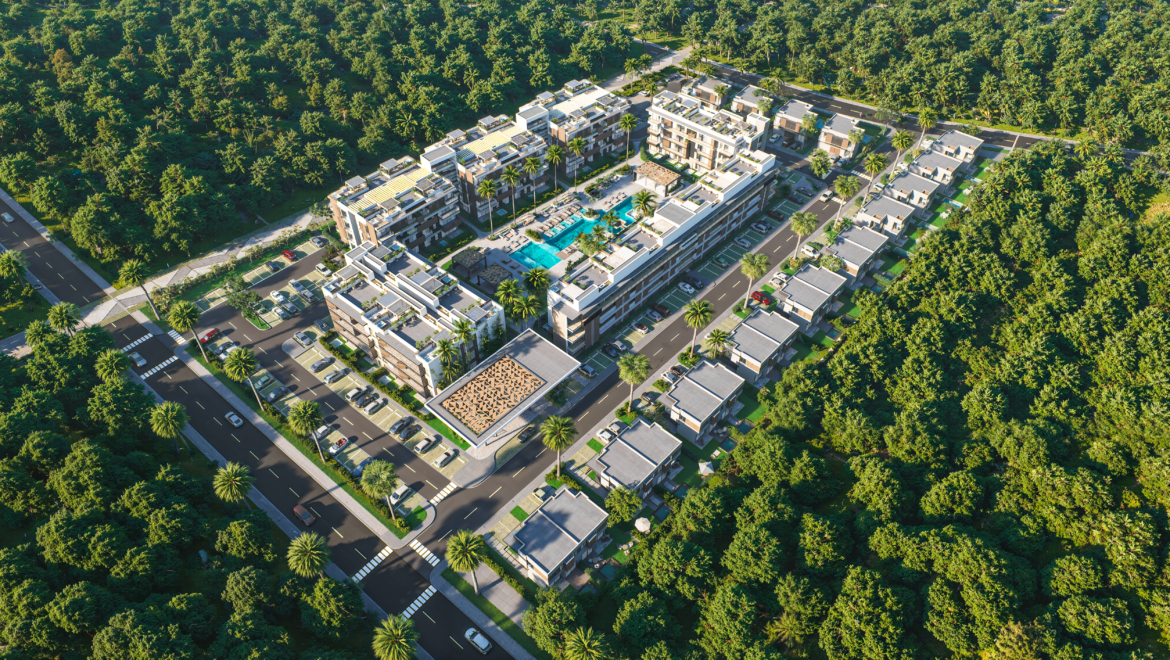 Aerial view of a modern apartment complex with a central swimming pool and palm trees, surrounded by dense green forest.