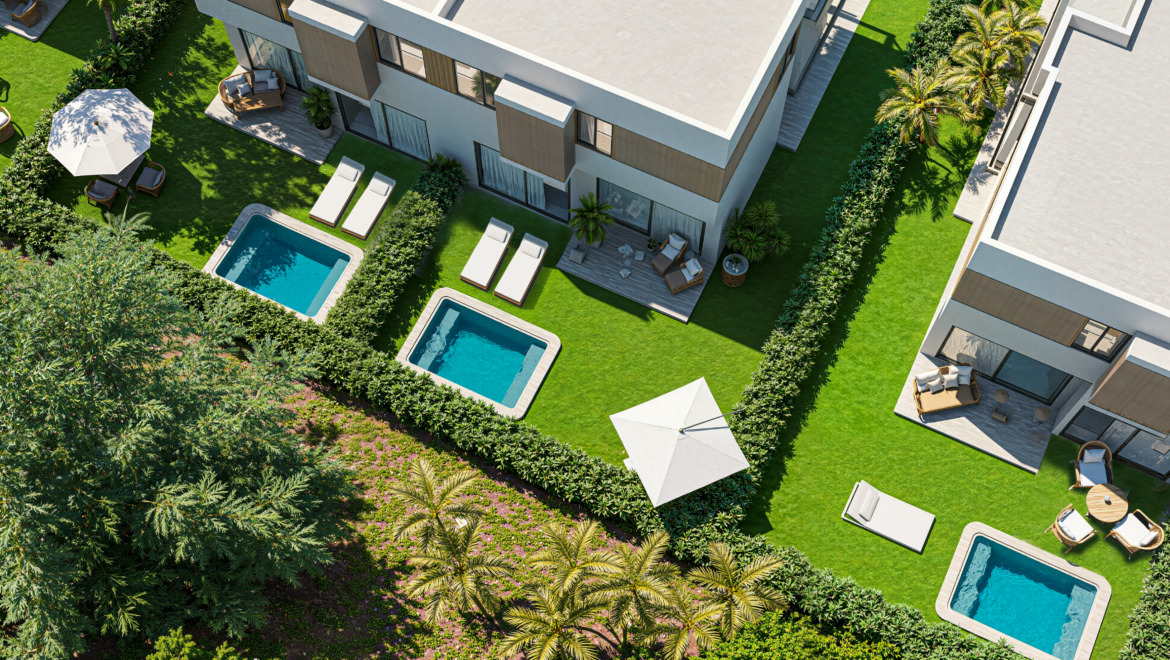 Aerial view of a modern apartment complex with multiple rectangular pools, lounge chairs, umbrellas, and green courtyards surrounded by hedges and trees.