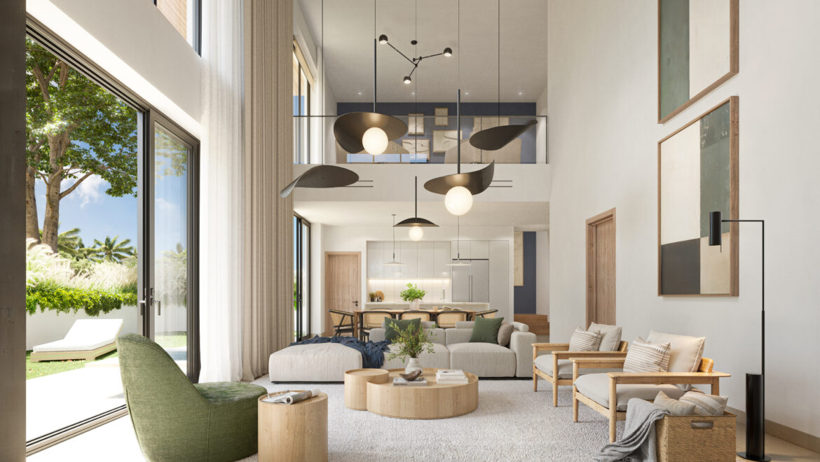 Bright open-plan living room with beige sectional sofa, green chair, and round wooden coffee tables facing large glass doors to a sunny outdoor garden.