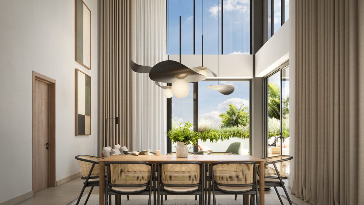 Modern dining room with a wooden table and woven chairs under sculptural pendant lighting, by large windows with beige curtains.
