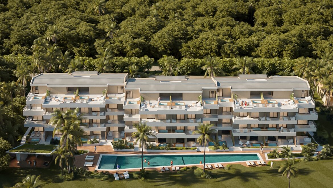 A modern multi-story resort-style apartment building with balconies, a central swimming pool, and tropical landscaping.