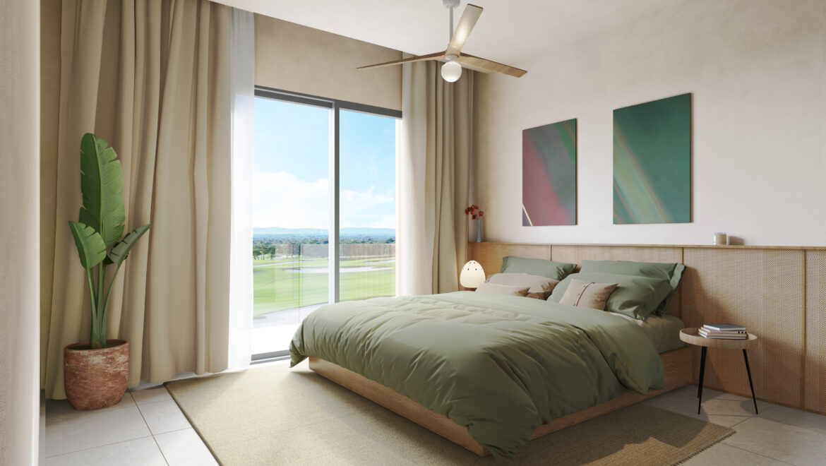 Bright, modern bedroom with a low platform bed in sage-green bedding, large windows with white curtains, and a ceiling fan above the bed.