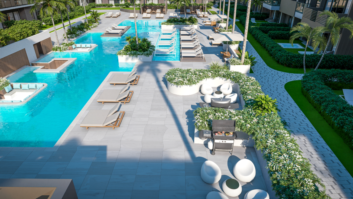 Aerial view of a luxury resort pool with white lounge chairs and palm trees along a gray tiled deck.