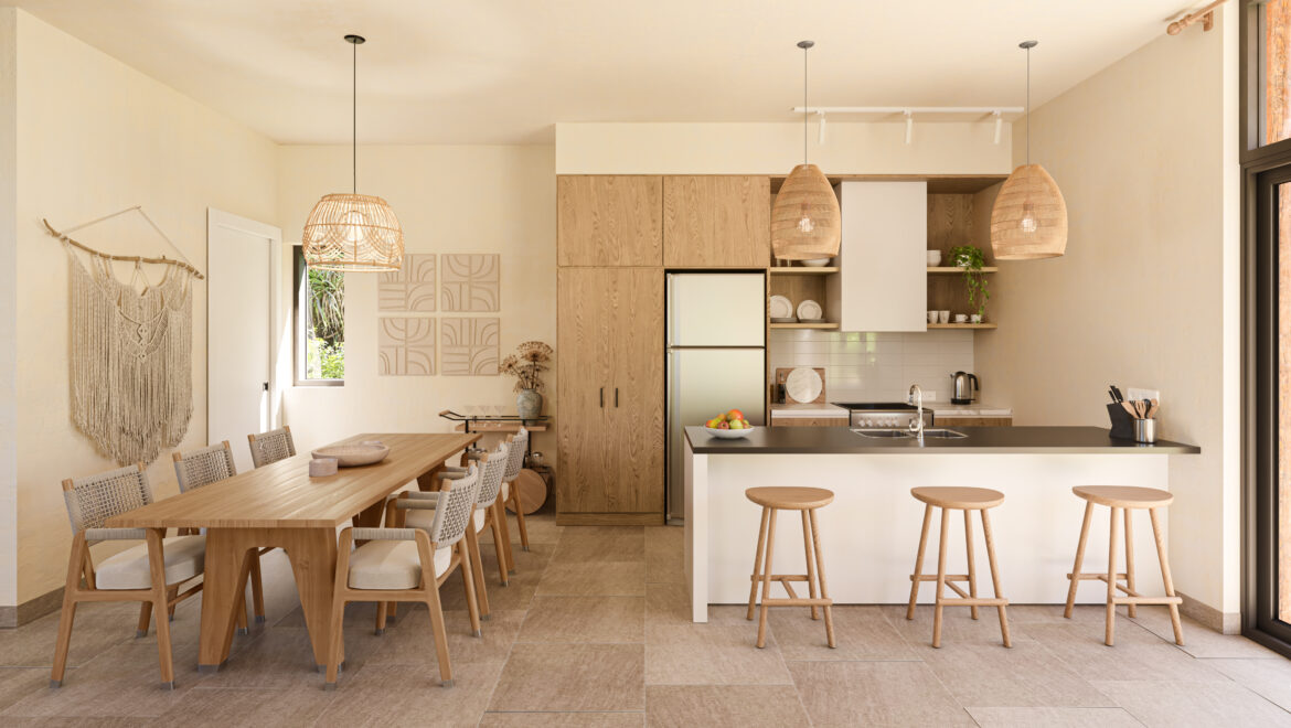Open-plan kitchen and dining area with a long wooden table, woven chairs, and a central kitchen island with bar stools and pendant lights.