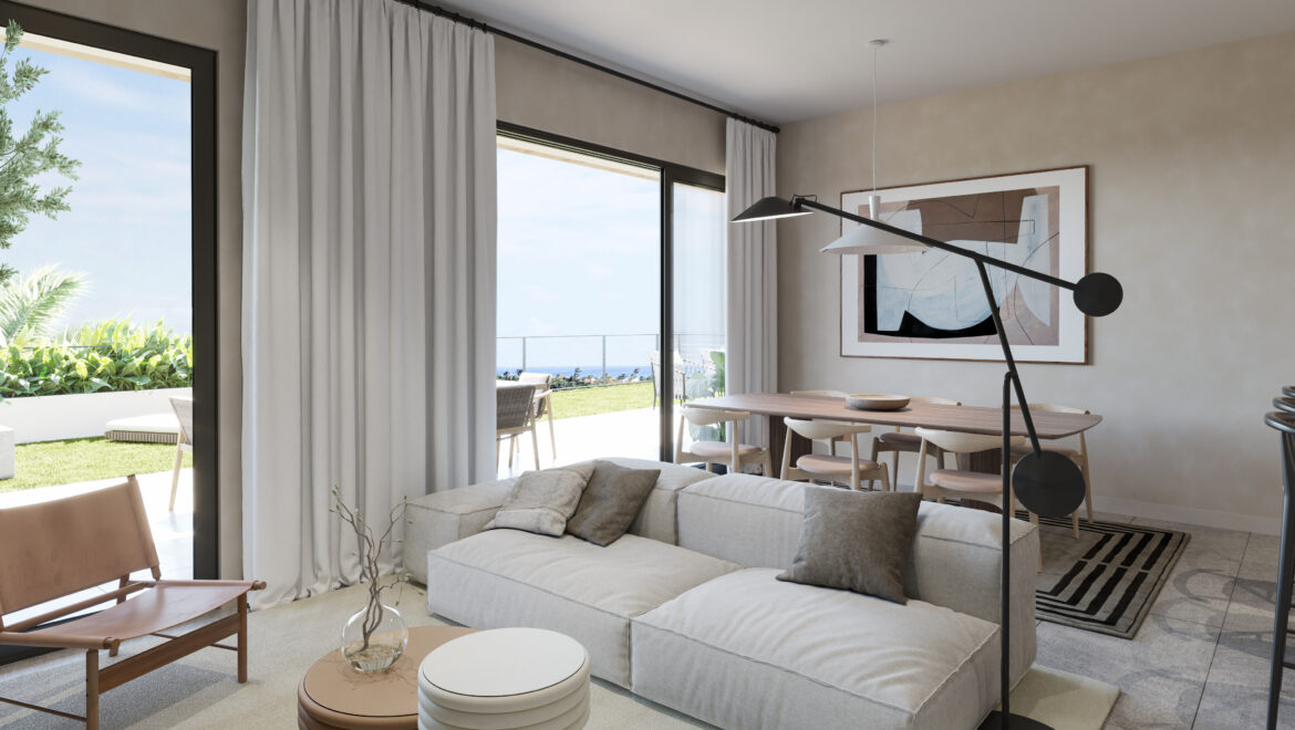Bright living/dining room with large glass doors to a patio, beige sofa, and abstract wall art; ocean view visible outside.