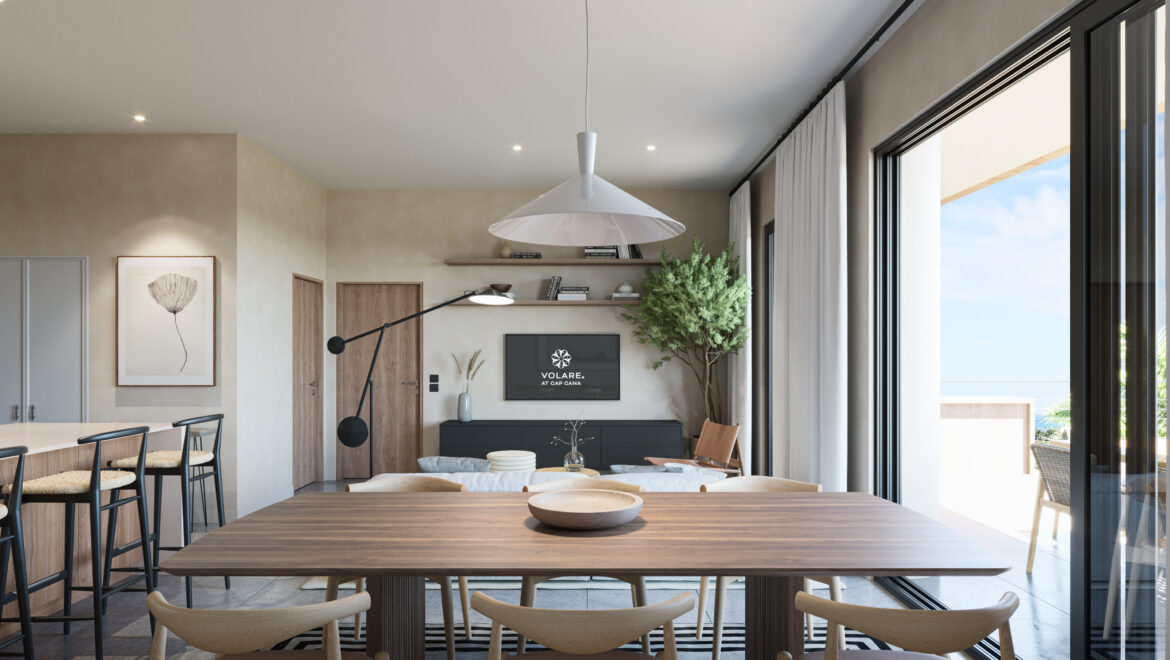 Open-plan dining area with a long wooden table, beige chairs, and large glass doors opening to a sunny balcony.