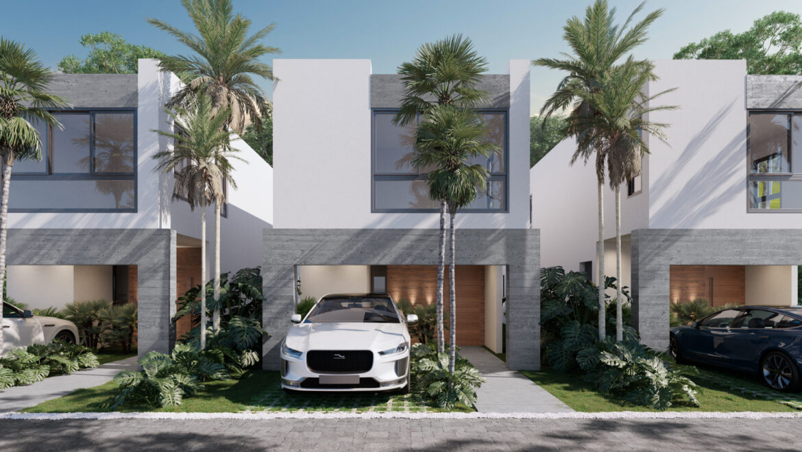 Front view of a row of modern white townhouses with gray stone accents, palm trees, and two parked cars in their driveways.