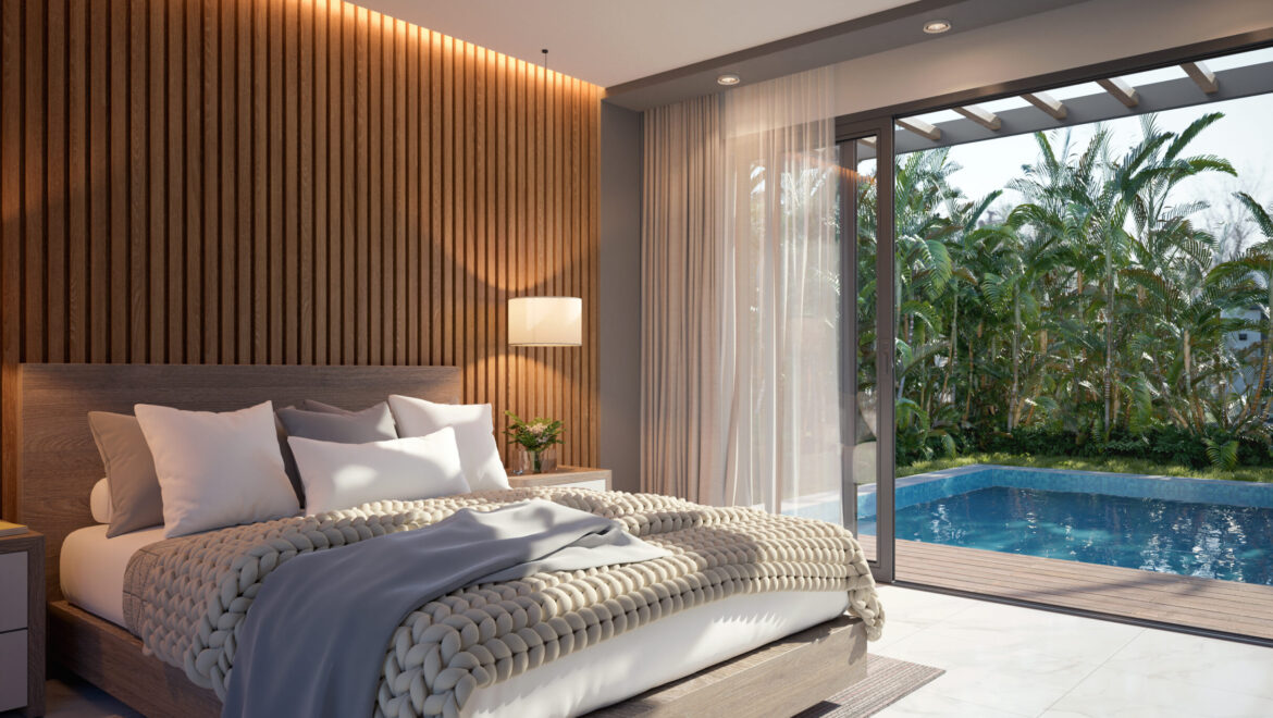 Bedroom with a wooden platform bed, chunky knit blanket, gray bedding, and sliding doors opening to a pool and palm trees outside.