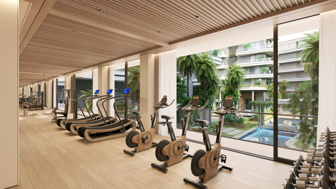 Modern gym with treadmills, ellipticals, and free weights along a glass wall overlooking palm trees and a residential building outside.