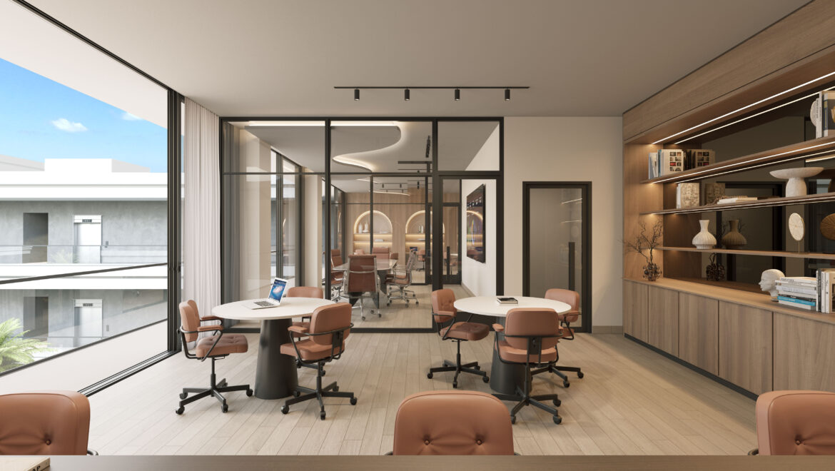 Bright, modern conference room with round white tables and orange swivel chairs, large glass walls, and a built‑in wooden shelving unit along the right filled with books and decor.