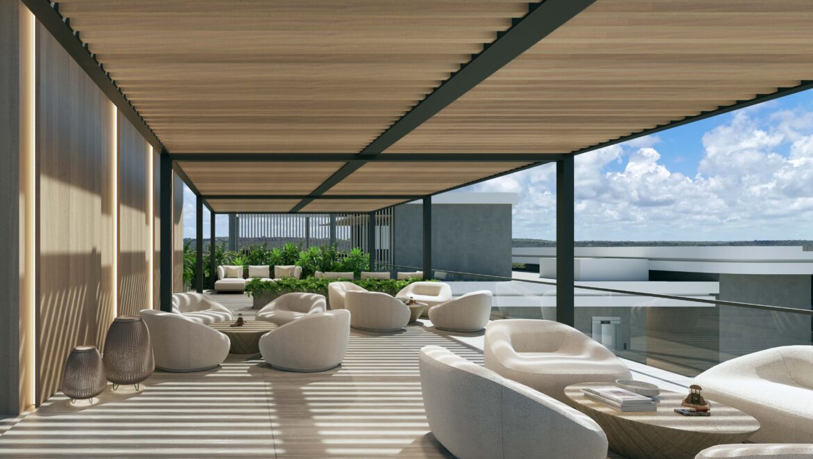 Open-air terrace lounge with cream rounded chairs, low coffee tables, and potted plants under a wooden slatted pergola overlooking the ocean.