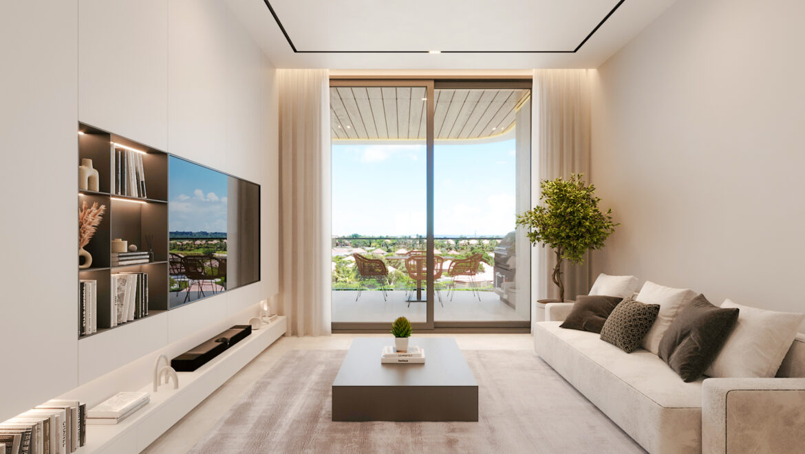 Modern living room with built-in shelving and a wall-mounted TV, neutral tones, and a glass balcony door opening to outdoor seating.