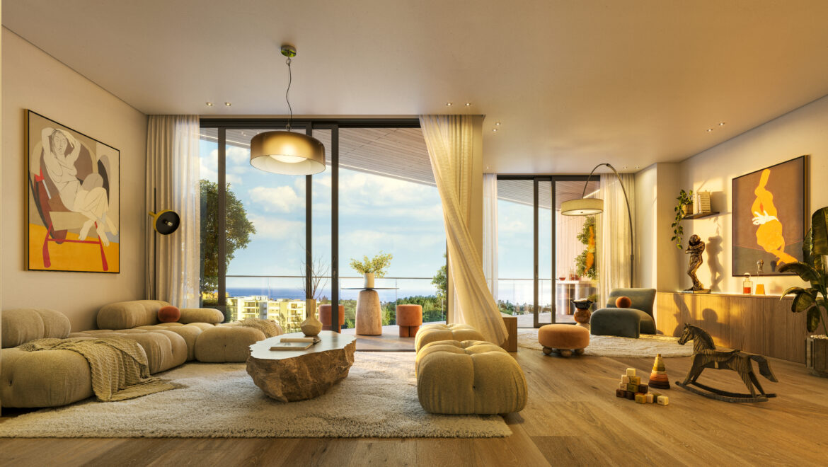 Spacious living room with beige modular sofas, abstract artwork, and large glass doors showing an outdoor view of trees and blue sky.