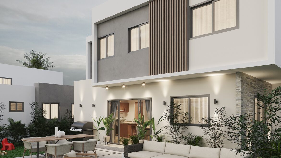 Modern two-story home with white exterior and large patio, outdoor dining table, lounge seating, and grill in the yard.
